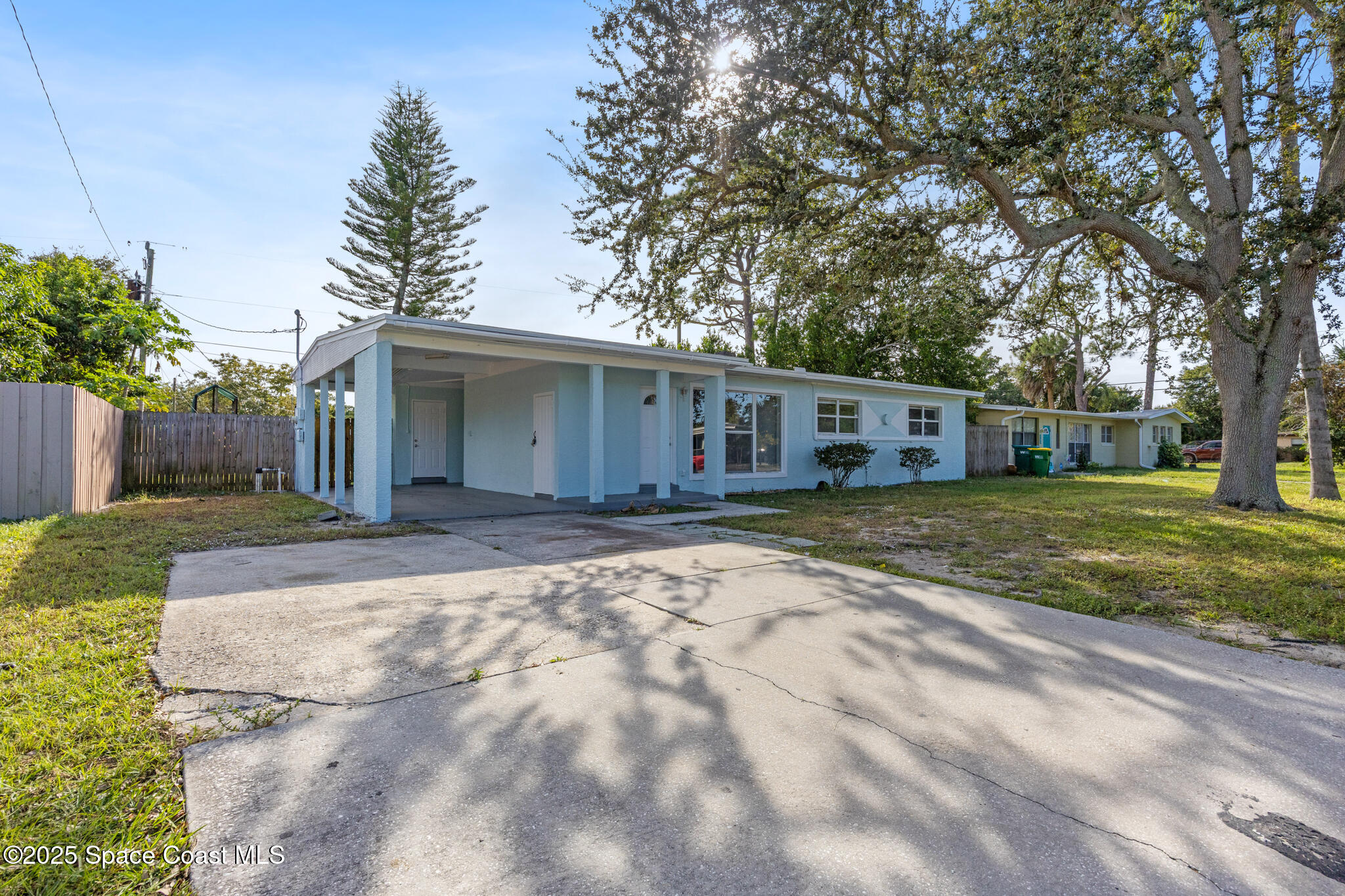 1107 Alamanda Lane Cocoa, FL 32922 - Photo 3 of 24 a view of house with backyard and trees