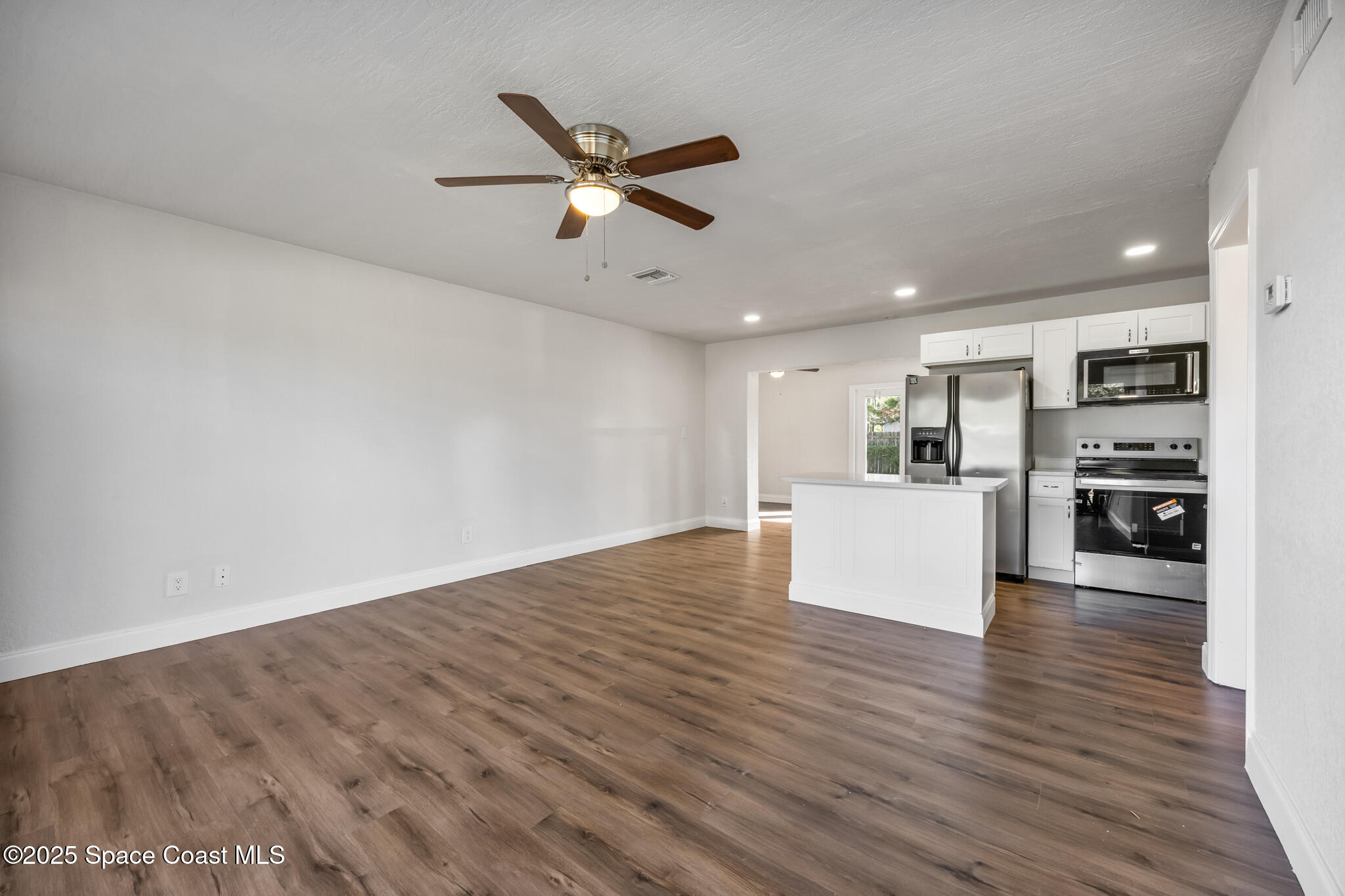 1107 Alamanda Lane Cocoa, FL 32922 - Photo 4 of 24 a view of empty room with wooden floor