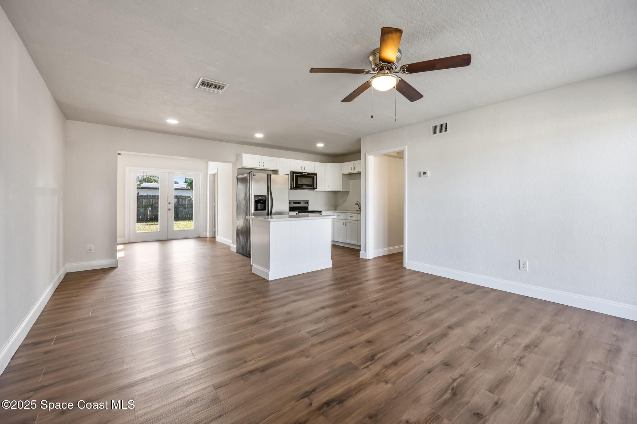 1107 Alamanda Lane Cocoa, FL 32922 - Photo 5 of 24 a view of a kitchen with a sink and a refrigerator