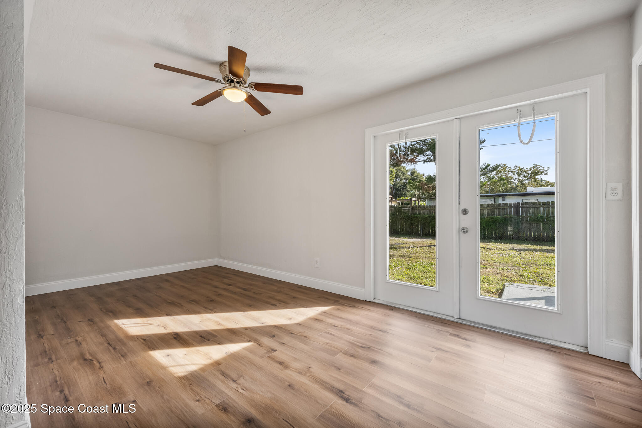 1107 Alamanda Lane Cocoa, FL 32922 - Photo 9 of 24 a view of an empty room with wooden floor and a window
