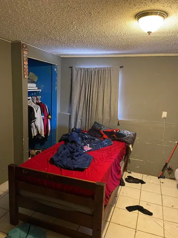 a bedroom with a bed and a closet