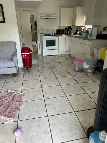 a kitchen with stainless steel appliances granite countertop a sink and a stove