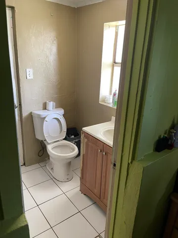 a white toilet sitting next to a small sink