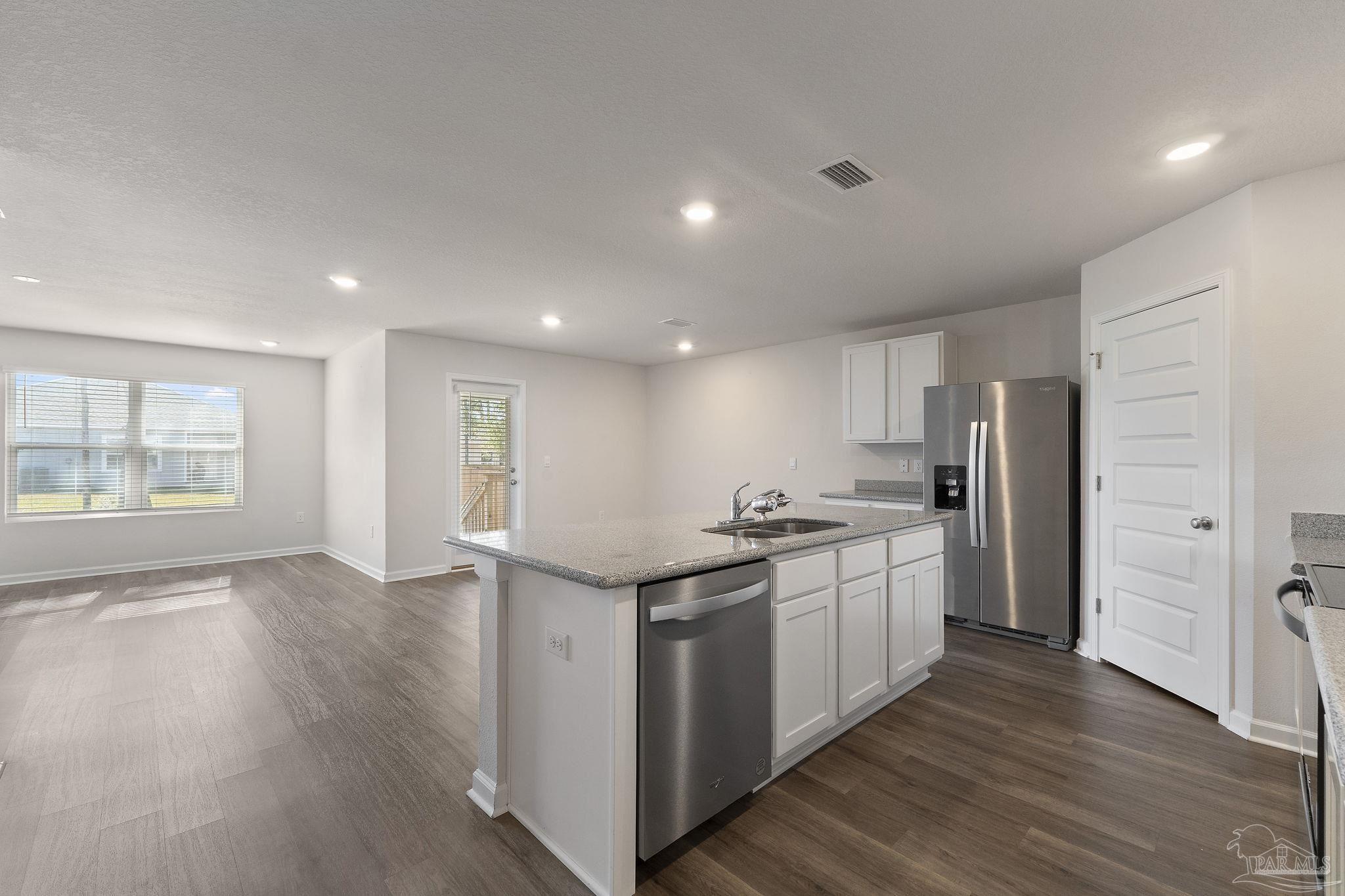 8669 Pathstone Boulevard Pensacola, FL 32526 - Photo 12 of 36 a kitchen with stainless steel appliances granite countertop a stove and a refrigerator