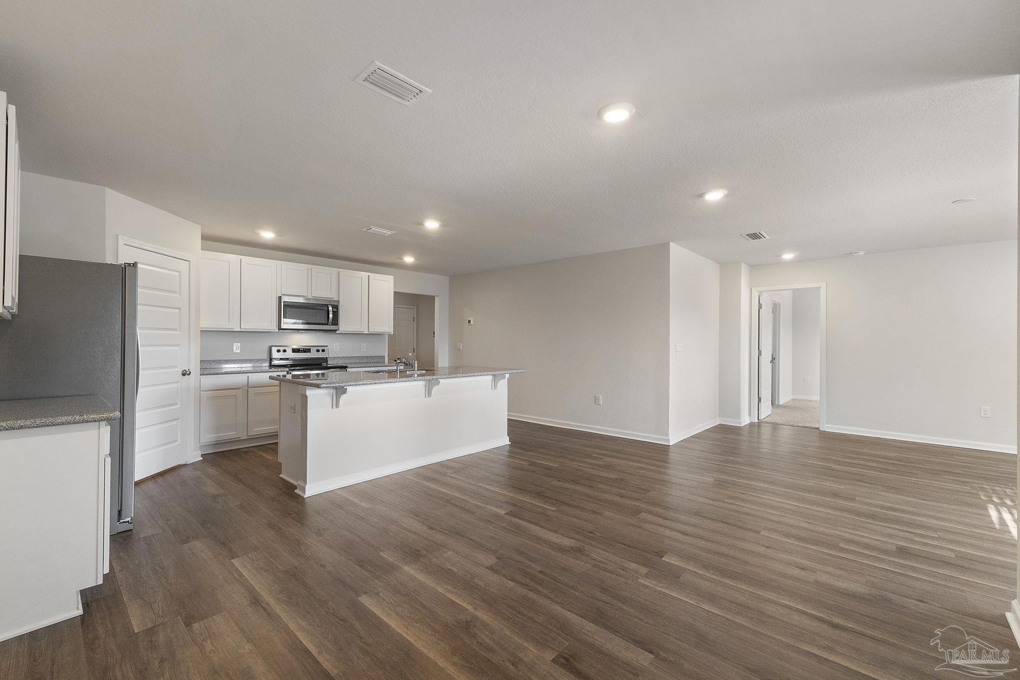8669 Pathstone Boulevard Pensacola, FL 32526 - Photo 13 of 36 a view of kitchen with wooden floor