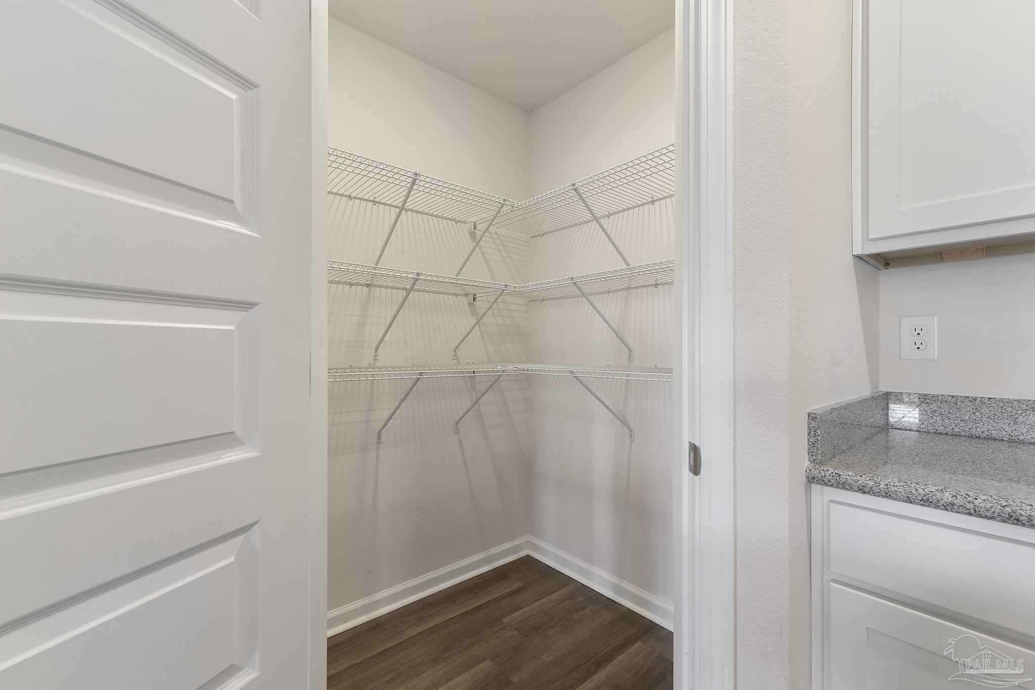 8669 Pathstone Boulevard Pensacola, FL 32526 - Photo 17 of 36 a bathroom with a granite countertop sink and white cabinets