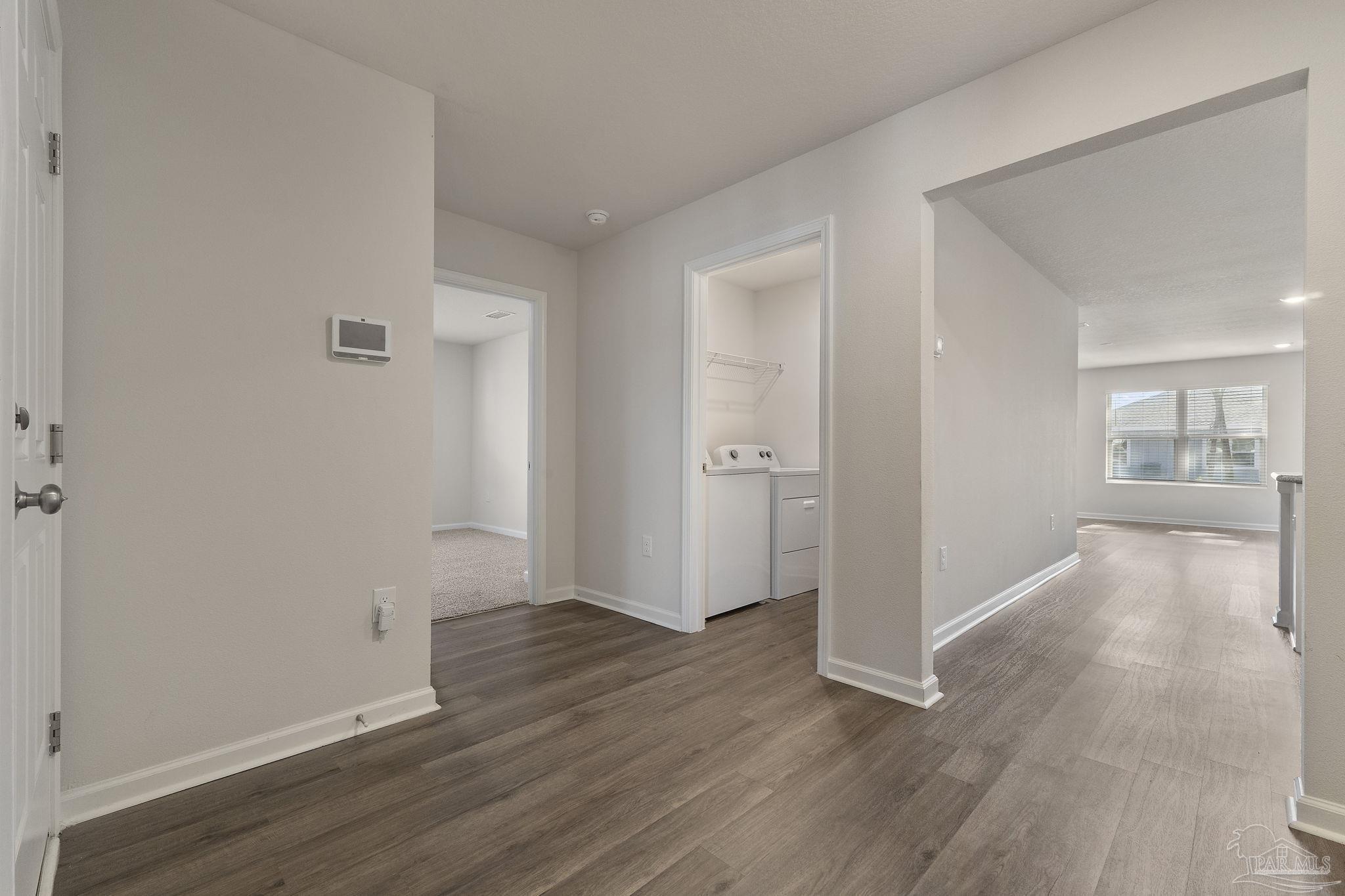 8669 Pathstone Boulevard Pensacola, FL 32526 - Photo 18 of 36 an empty room with wooden floor and windows