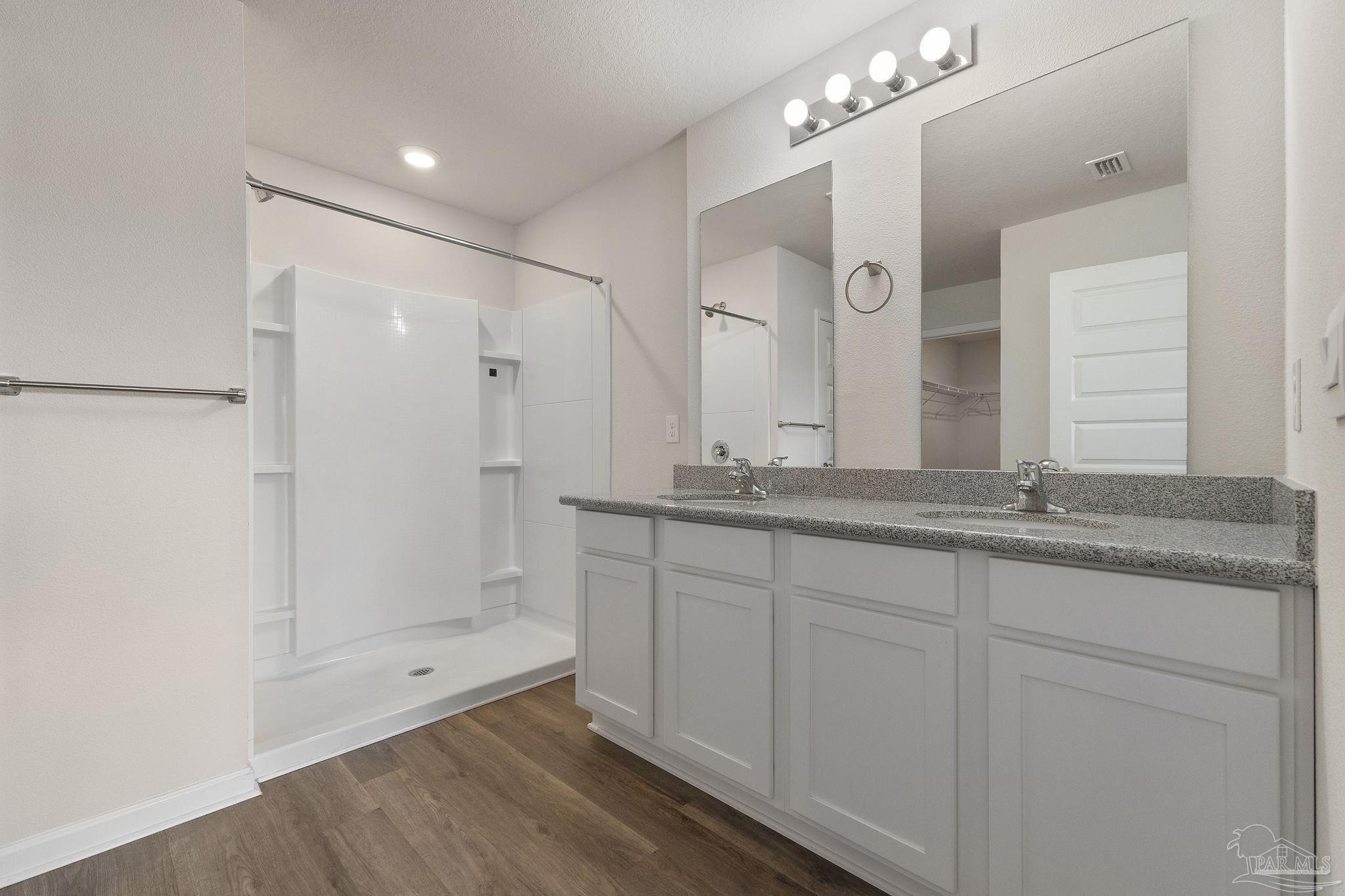 8669 Pathstone Boulevard Pensacola, FL 32526 - Photo 22 of 36 a bathroom with double vanity sinks and a shower