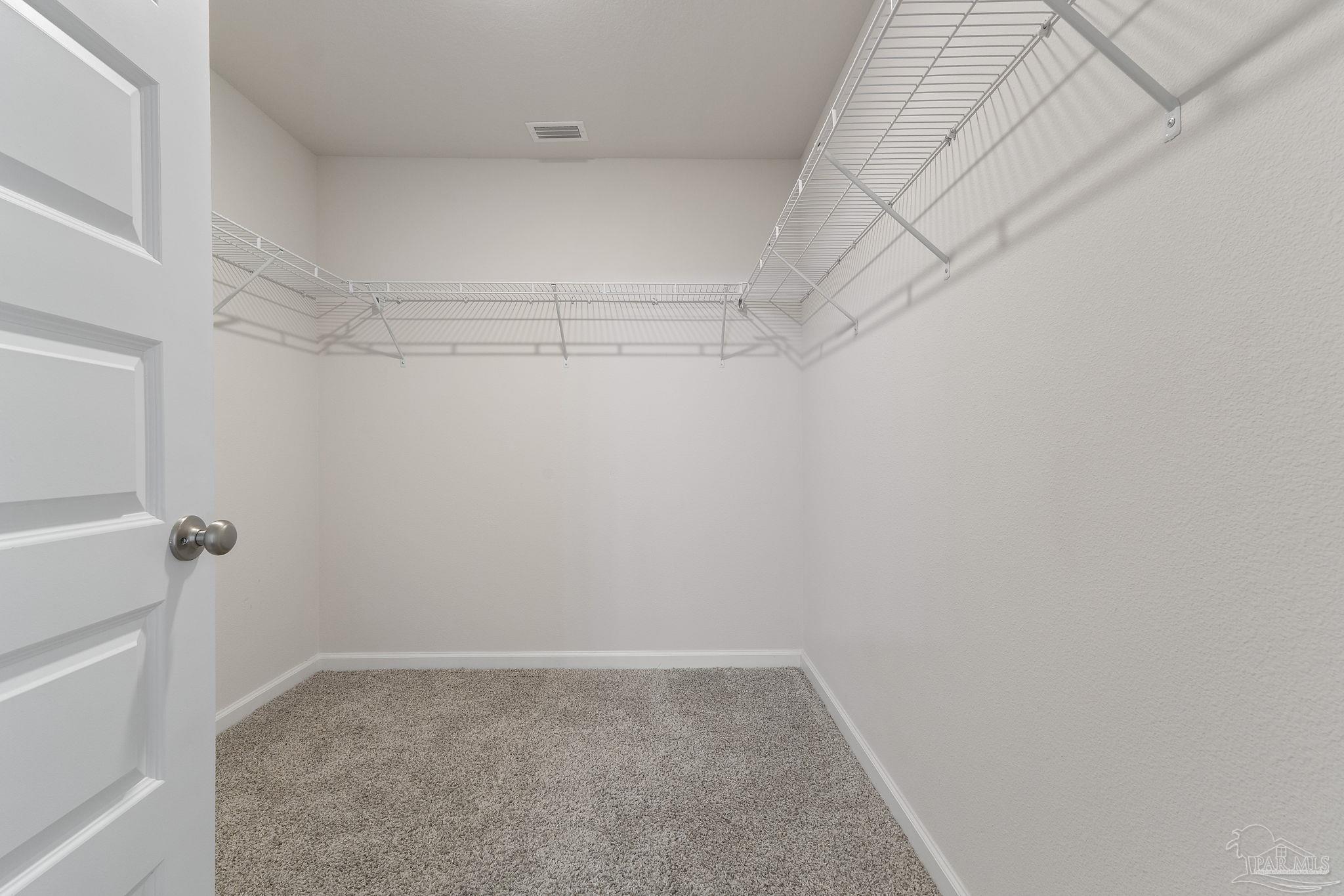 8669 Pathstone Boulevard Pensacola, FL 32526 - Photo 23 of 36 a view of a room with racks on the wall