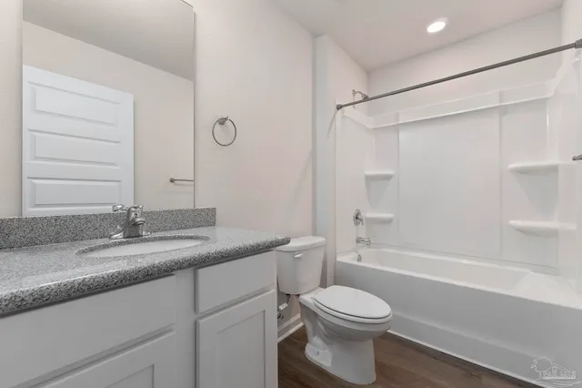 a front view of house with a garden and patio