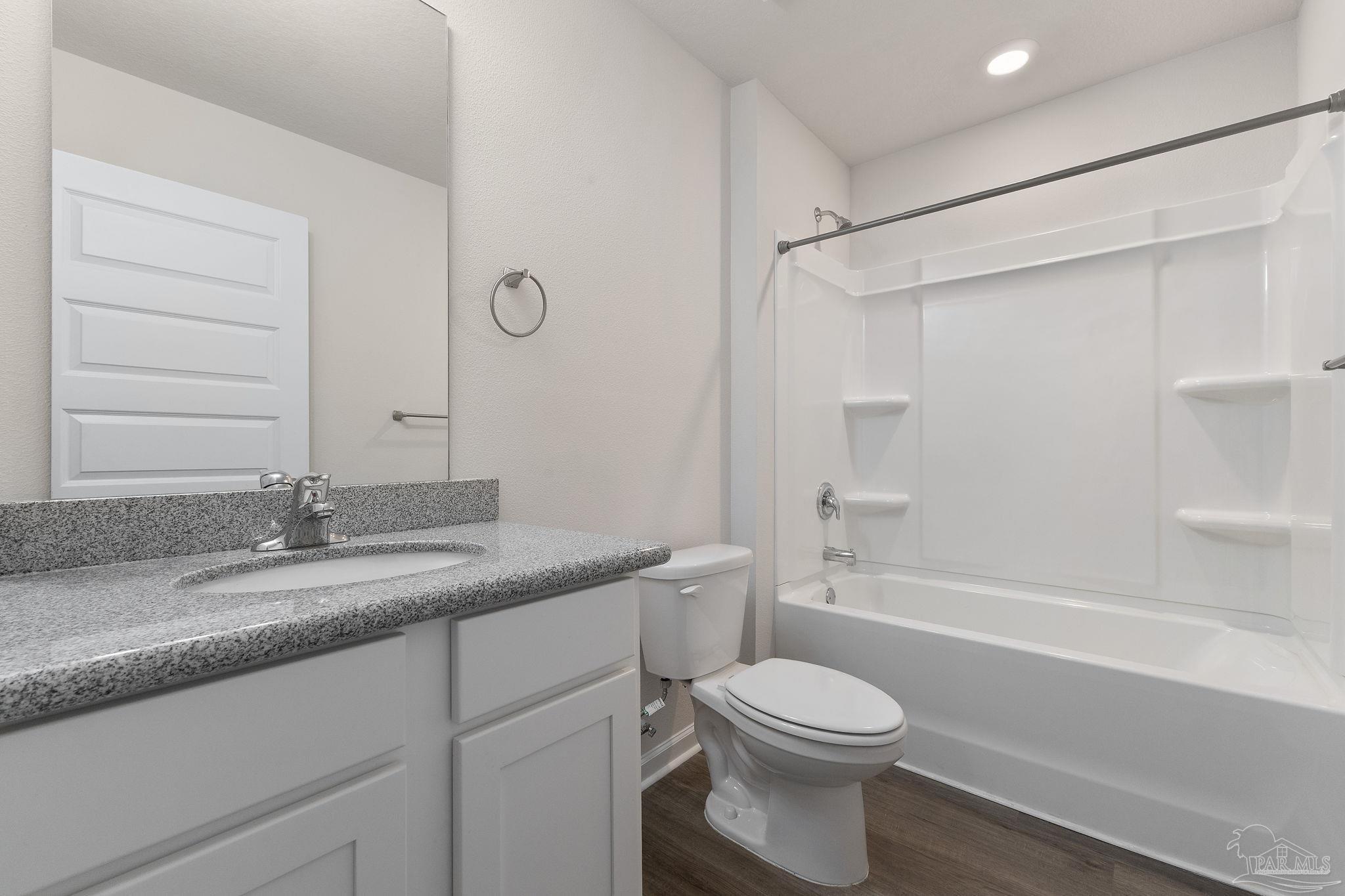 8669 Pathstone Boulevard Pensacola, FL 32526 - Photo 31 of 36 a bathroom with a granite countertop sink toilet and shower