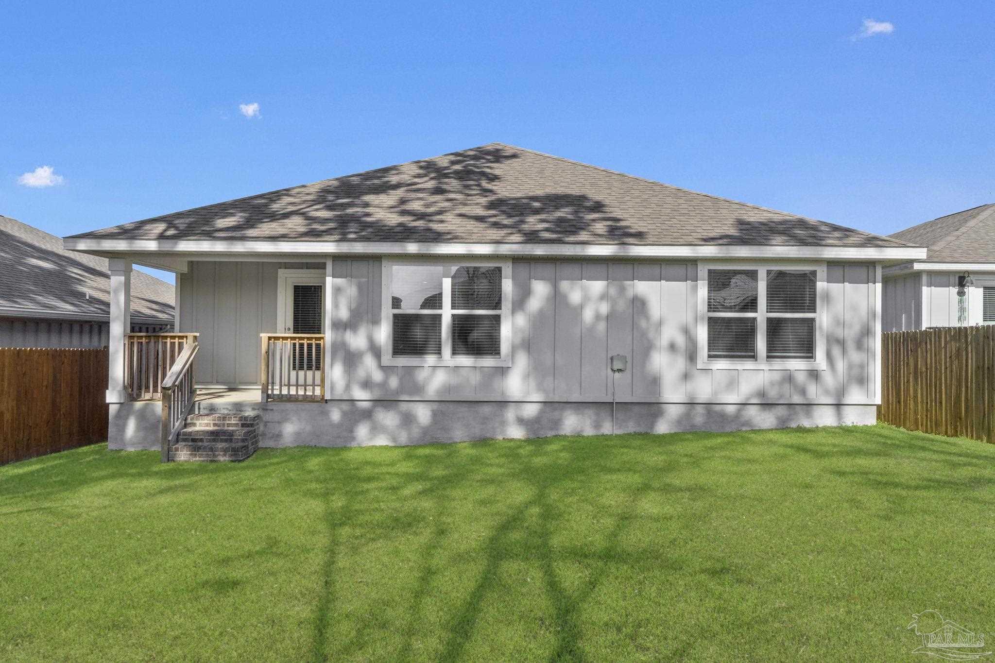8669 Pathstone Boulevard Pensacola, FL 32526 - Photo 32 of 36 a front view of house with a garden and patio