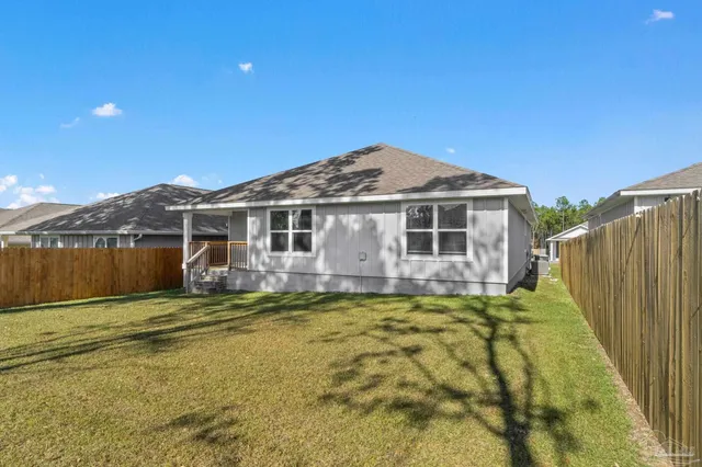 a house view with swimming pool in front of it