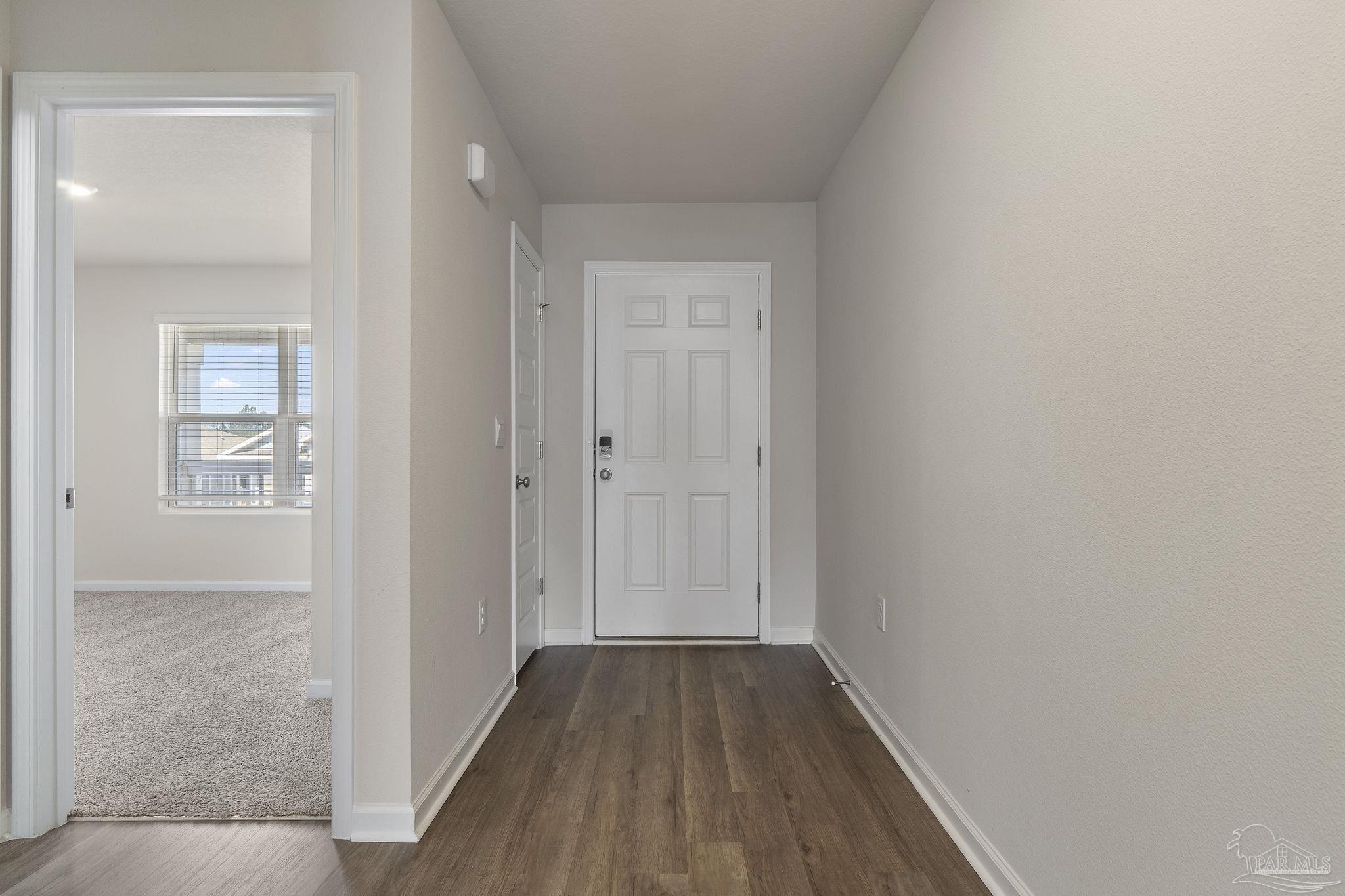 8669 Pathstone Boulevard Pensacola, FL 32526 - Photo 6 of 36 a view of a hallway with wooden floor