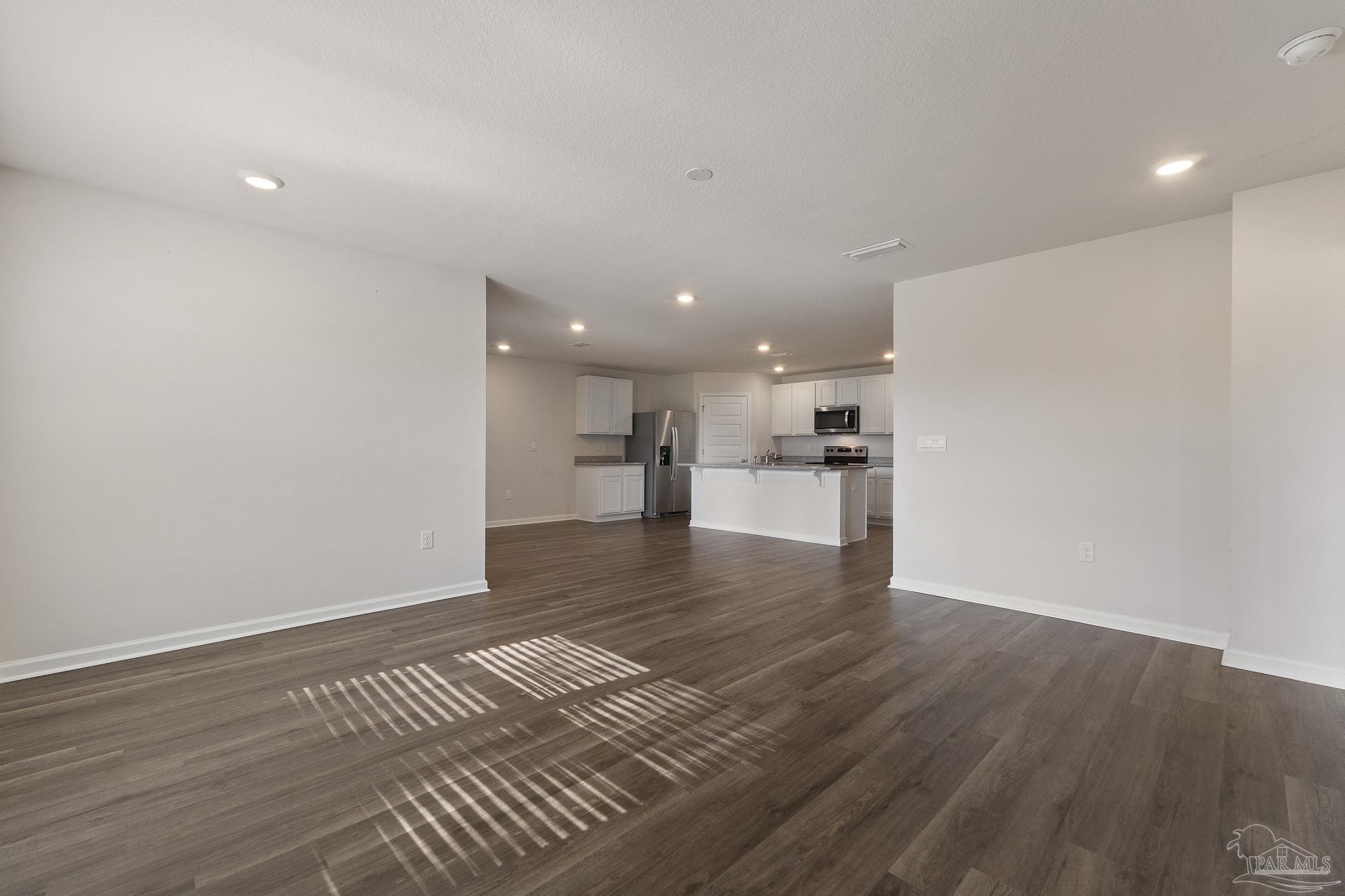 8669 Pathstone Boulevard Pensacola, FL 32526 - Photo 8 of 36 a view of empty room with wooden floor