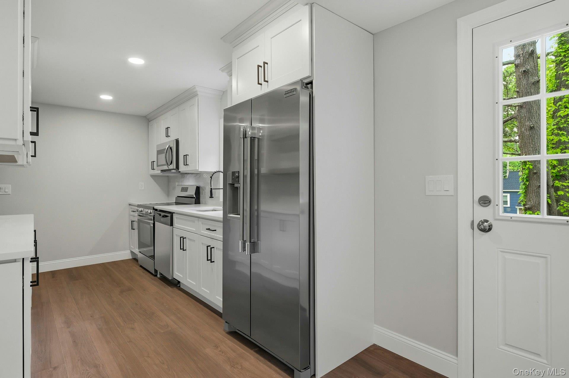 101 Rustic Road Centereach, NY 11720 - Photo 18 of 42 a kitchen with cabinets and stainless steel appliances