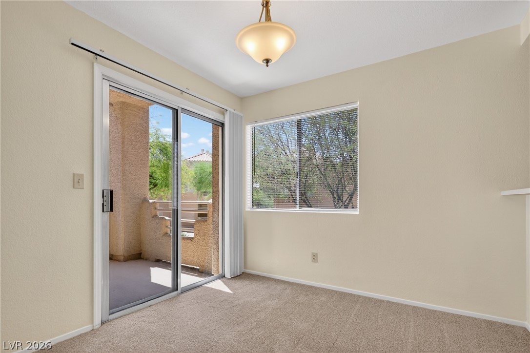 2241 Highpointe Drive, Unit 101 Laughlin, NV 89029 - Photo 12 of 23 This bright space features a glass sliding door and large window, offering abundant natural light and outdoor access.