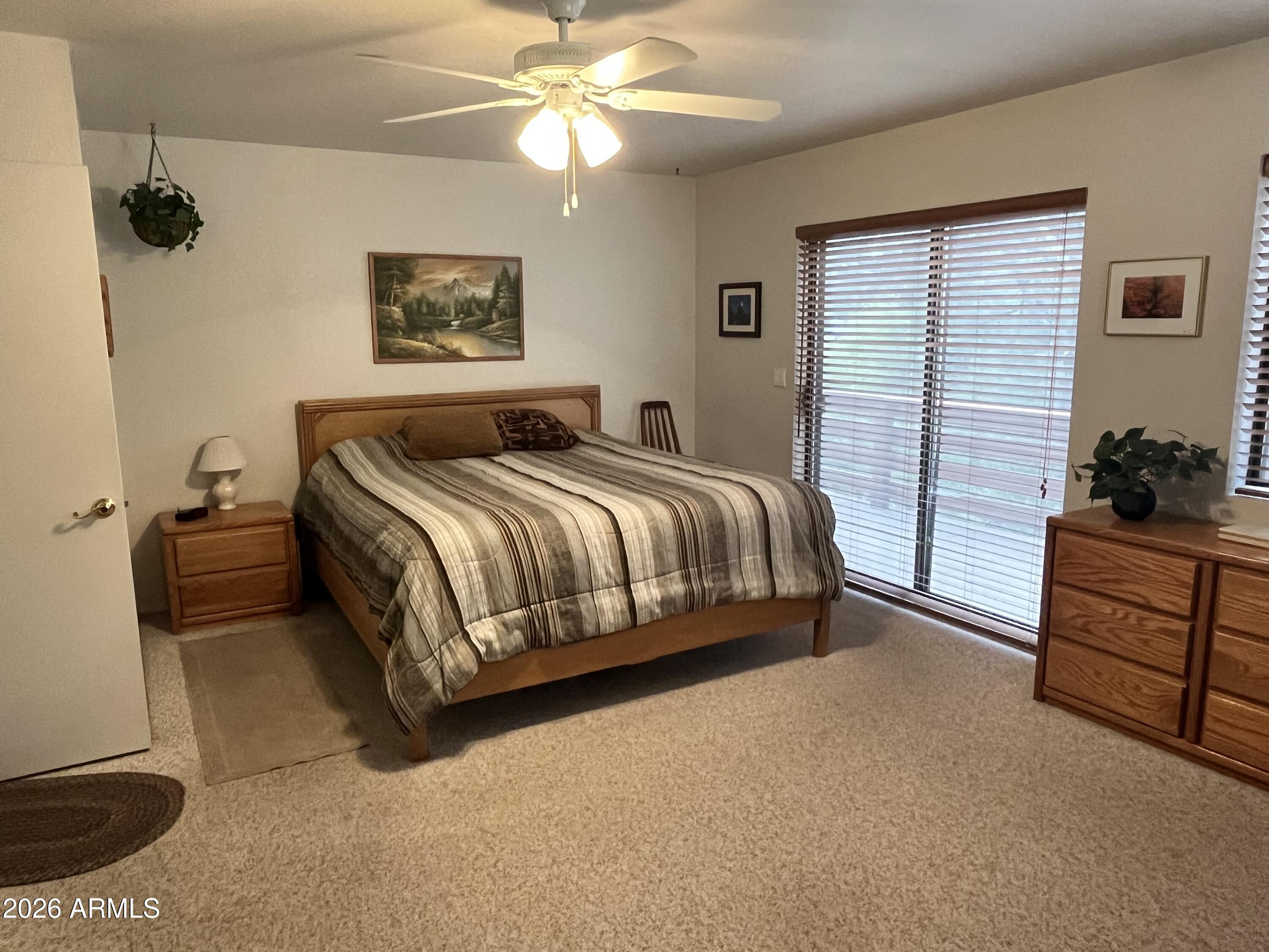 1006 North Matterhorn Road Payson, AZ 85541 - Photo 14 of 37 a bedroom with a bed and a chandelier
