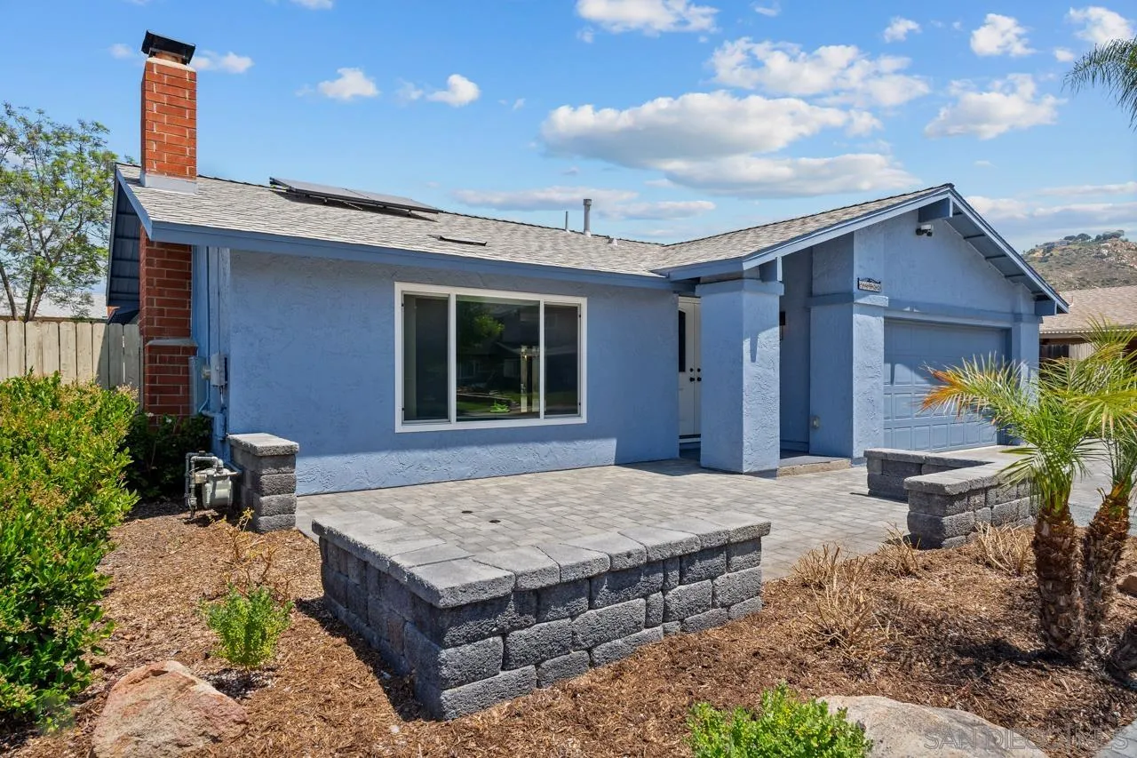 a wooden bench sitting in front of a house