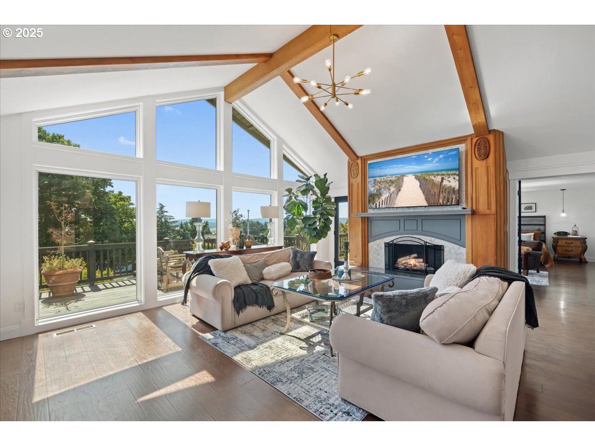 8014 Southeast Middle Way Vancouver, WA 98664 - Photo 11 of 47 a living room with furniture a floor to ceiling window and a fireplace