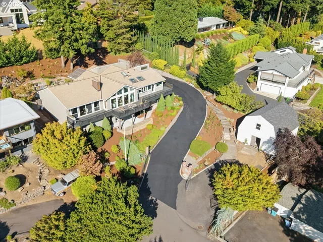 an aerial view of a swimming pool with outdoor seating