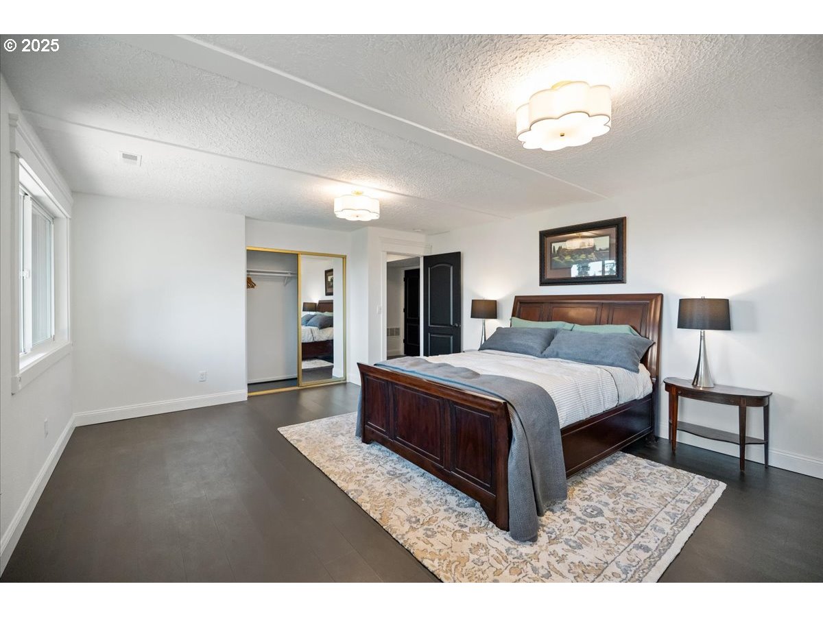 8014 Southeast Middle Way Vancouver, WA 98664 - Photo 26 of 47 a bedroom with a large bed and a chandelier