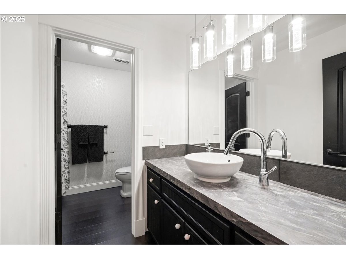 8014 Southeast Middle Way Vancouver, WA 98664 - Photo 30 of 47 a bathroom with a granite countertop sink a toilet and a mirror