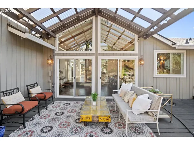 a view of a house with backyard and sitting area