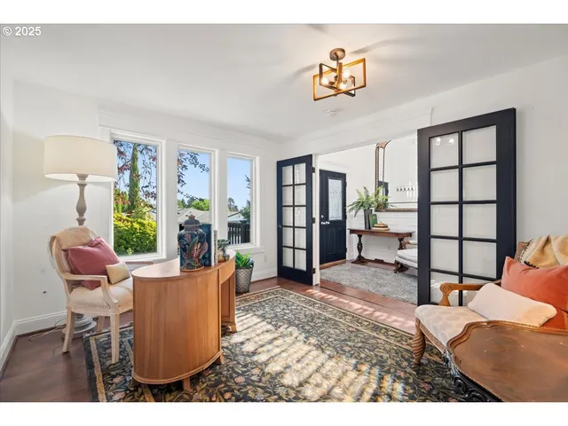 a living room with furniture a window and a flat screen tv