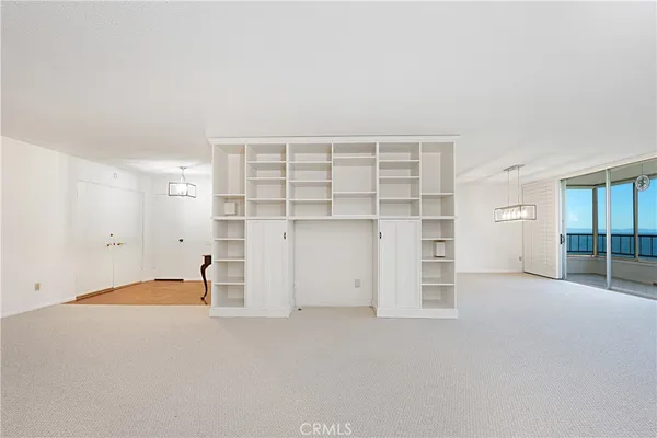 an empty room with closet and windows
