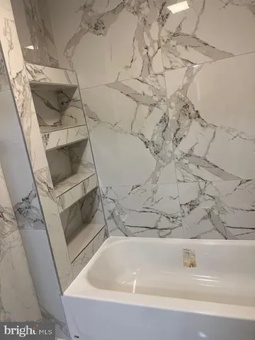 a bathroom with a toilet and a bathtub