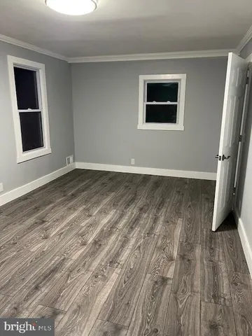 a view of a room with wooden floor