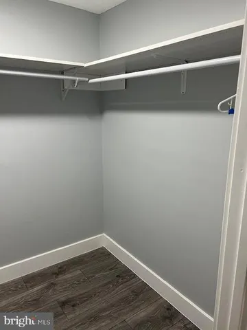 a view of walk in closet with empty racks