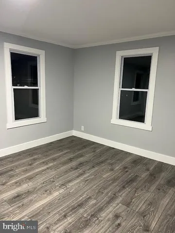 a view of a room with wooden floor and staircase