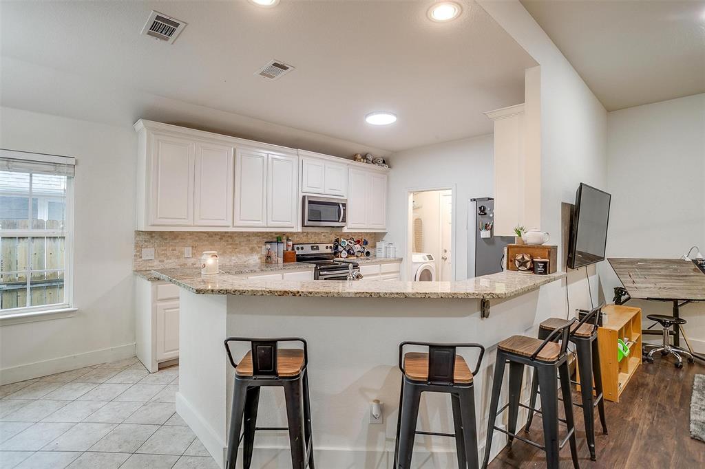 228 Lovers Path Drive Springtown, TX 76082 - Photo 16 of 40 Kitchen featuring white cabinetry, washer / dryer, stainless steel appliances, and visible vents