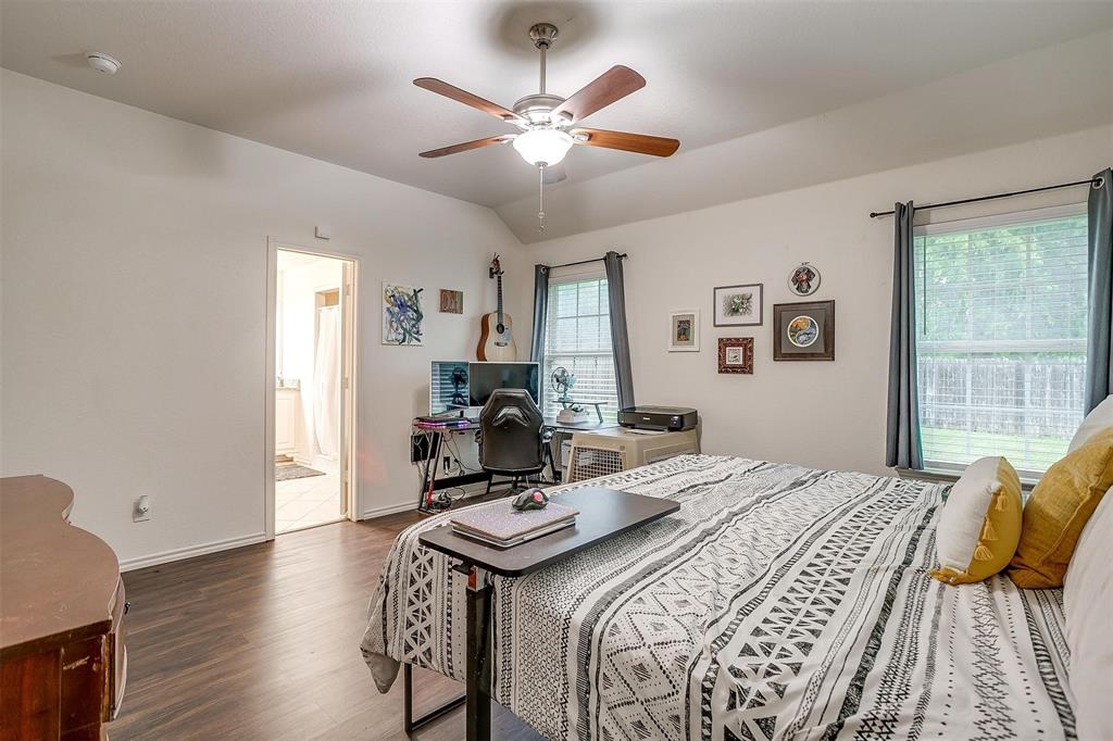 228 Lovers Path Drive Springtown, TX 76082 - Photo 23 of 40 Bedroom with baseboards, connected bathroom, a ceiling fan, and wood finished floors
