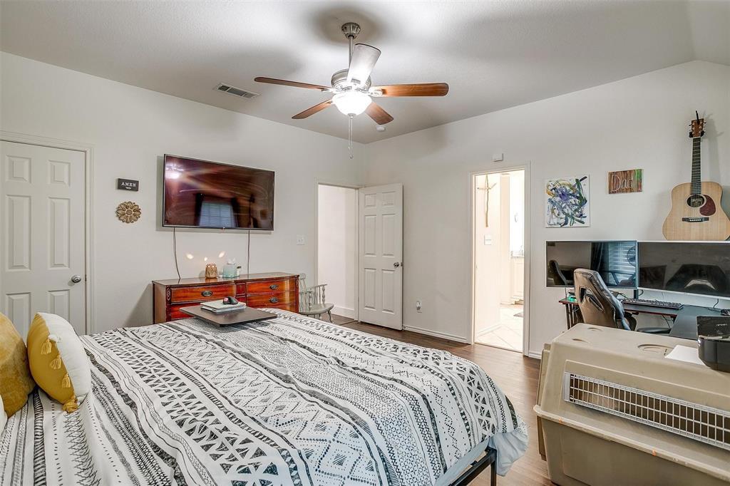 228 Lovers Path Drive Springtown, TX 76082 - Photo 24 of 40 Bedroom featuring wood finished floors, ensuite bath, visible vents, ceiling fan, and baseboards