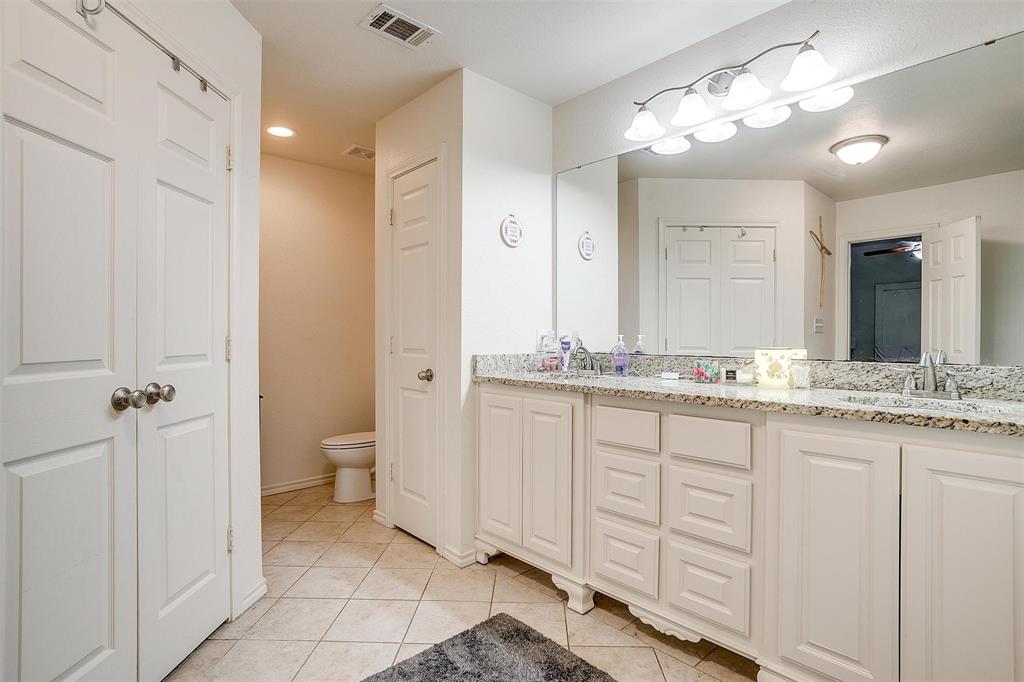 228 Lovers Path Drive Springtown, TX 76082 - Photo 27 of 40 Full bathroom featuring a sink, toilet, visible vents, tile patterned floors, and double vanity