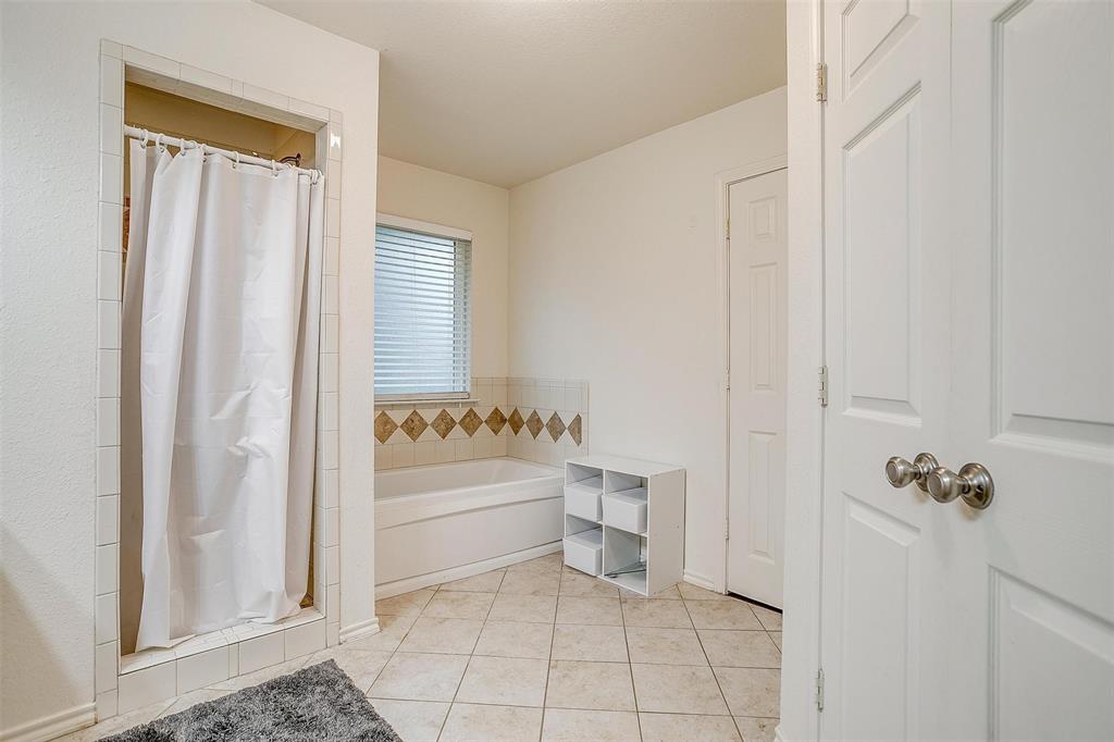 228 Lovers Path Drive Springtown, TX 76082 - Photo 29 of 40 Full bath with a shower stall, tile patterned flooring, and a garden tub