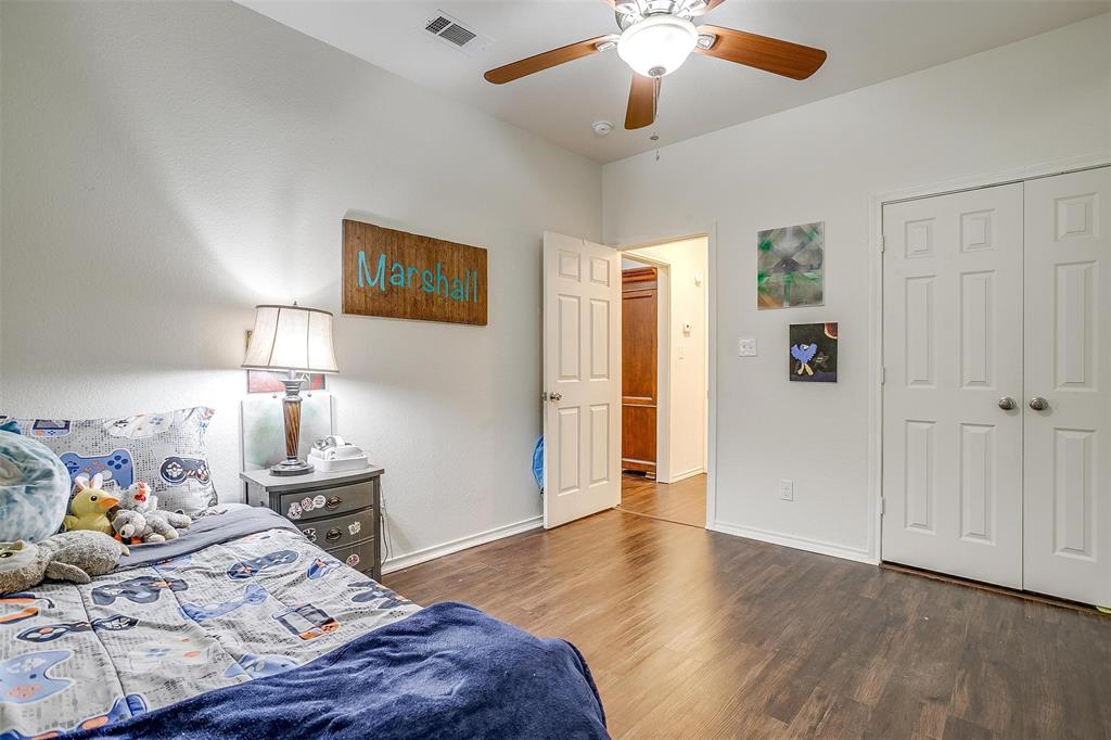 228 Lovers Path Drive Springtown, TX 76082 - Photo 35 of 40 Bedroom with wood finished floors, a closet, visible vents, baseboards, and ceiling fan