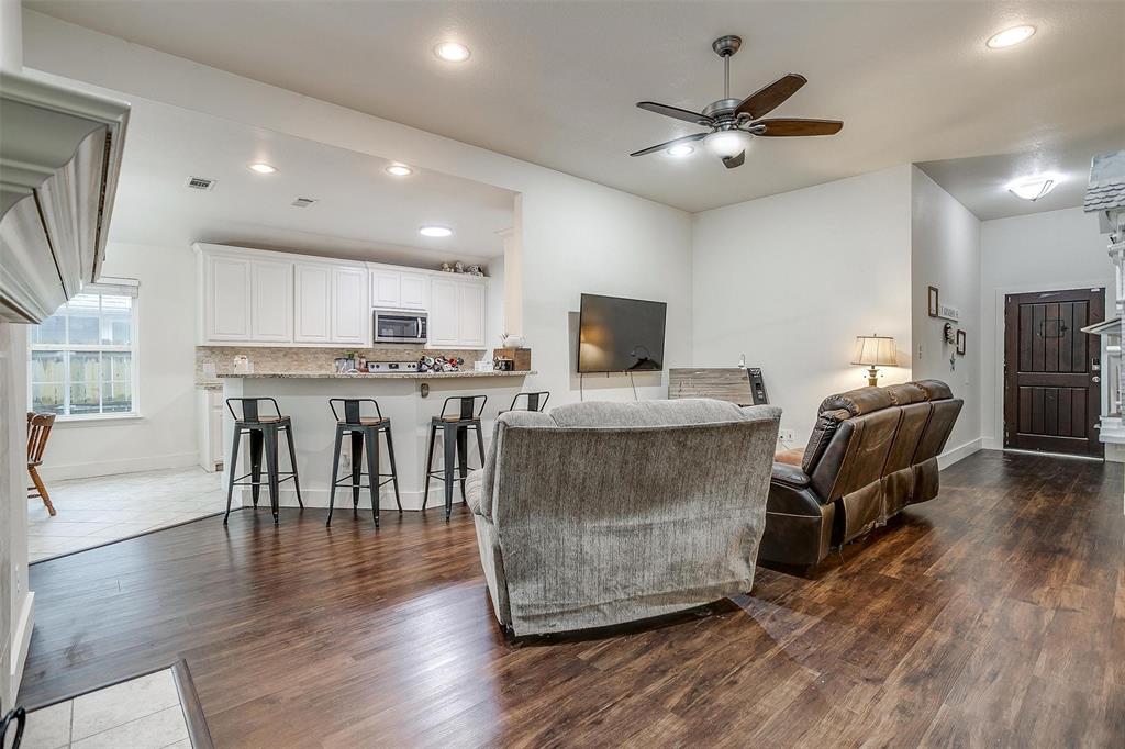 228 Lovers Path Drive Springtown, TX 76082 - Photo 8 of 40 Living area featuring a ceiling fan, dark wood-style flooring, baseboards, and visible vents