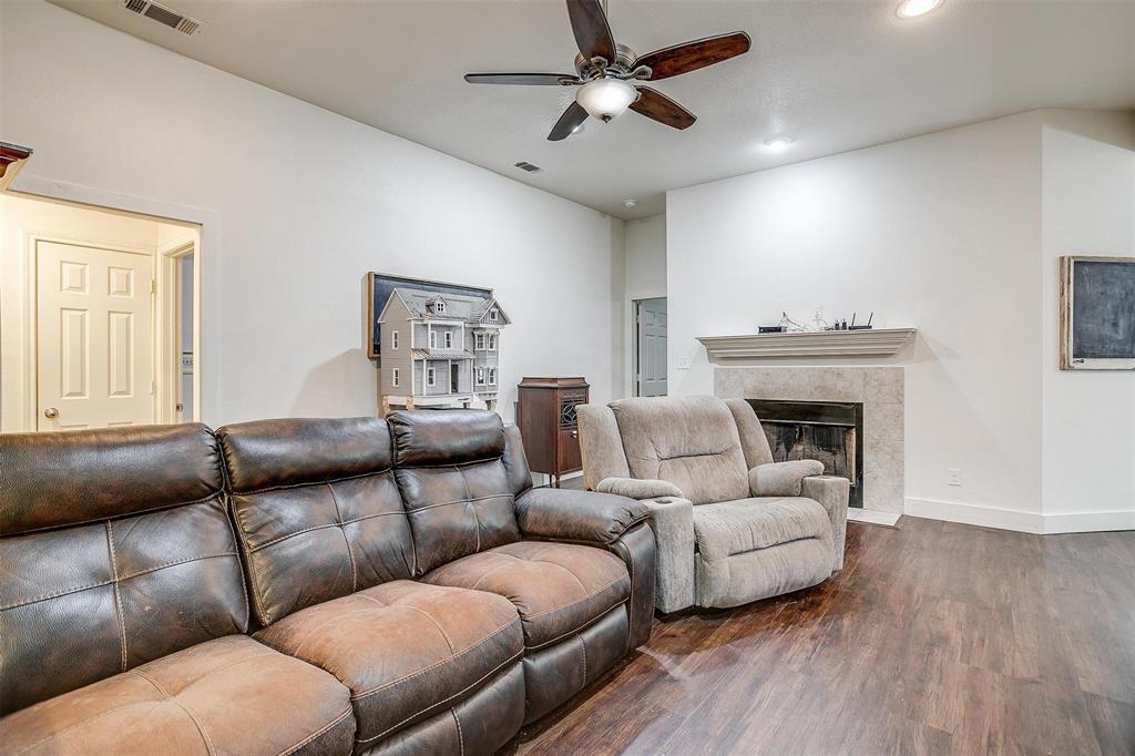 228 Lovers Path Drive Springtown, TX 76082 - Photo 10 of 40 Living room featuring a premium fireplace, recessed lighting, dark wood-style flooring, ceiling fan, and visible vents