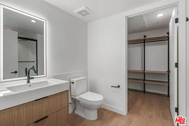 a bathroom with a toilet a sink and mirror