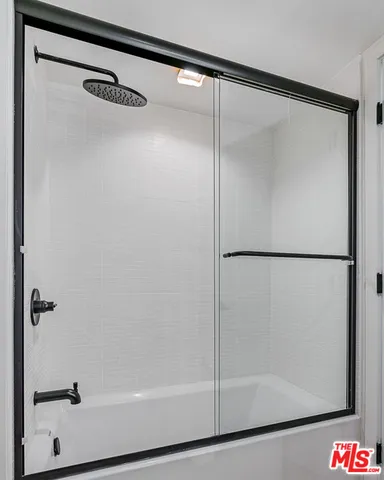 a bathroom with a glass shower door