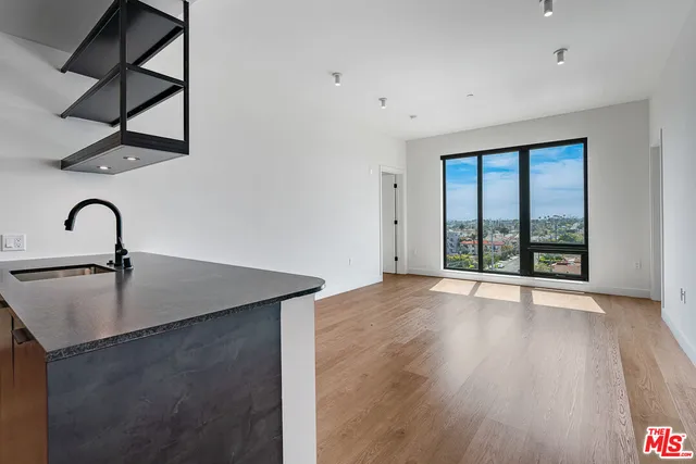 a view of a room with wooden floor and window