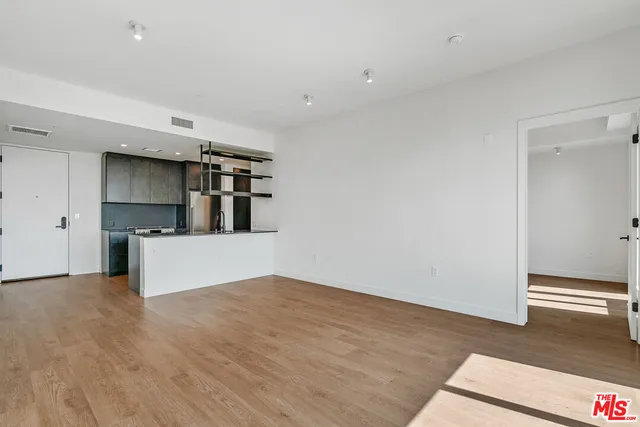 a view of a kitchen with a sink and a refrigerator