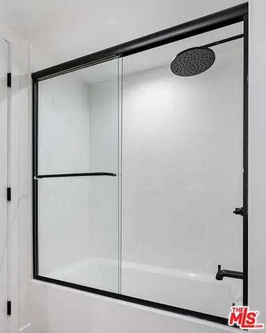 a bathroom with a glass shower door
