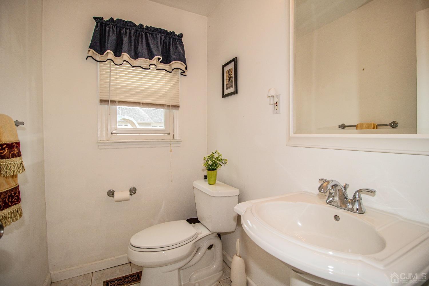29 Devon Drive Piscataway, NJ 08854 - Photo 13 of 23 a bathroom with a sink a toilet and mirror