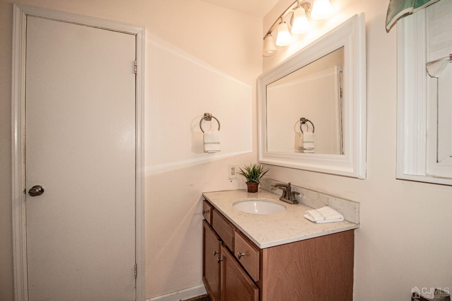 29 Devon Drive Piscataway, NJ 08854 - Photo 16 of 23 a bathroom with a sink a vanity and a mirror