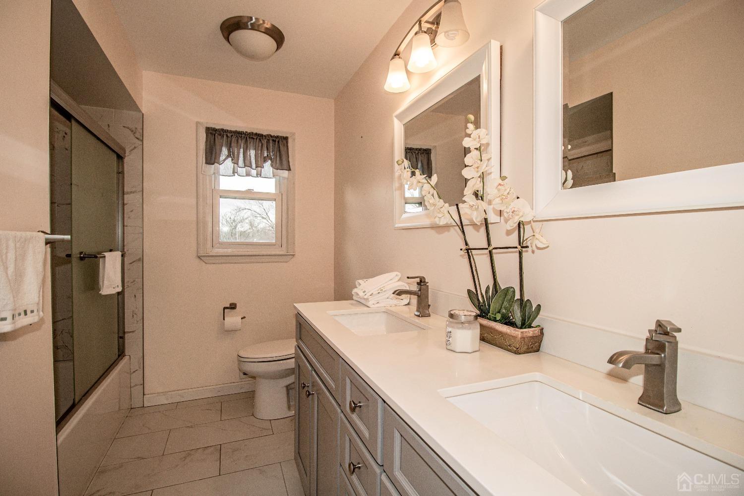 29 Devon Drive Piscataway, NJ 08854 - Photo 21 of 23 a bathroom with a sink a toilet and shower